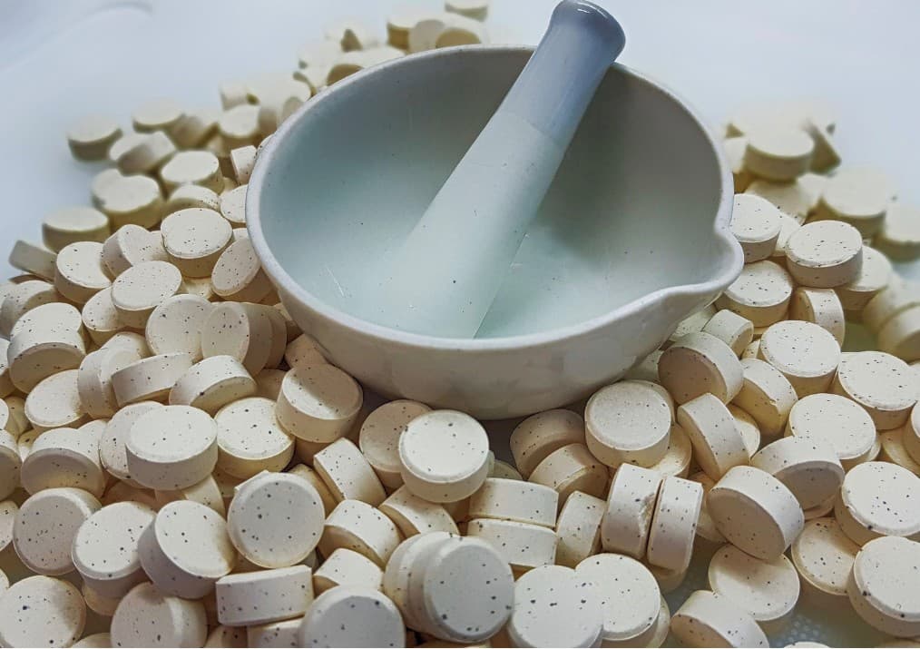 Compounded pet medication tablets prepared in a pharmacy mortar