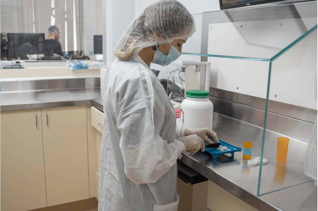 Licensed compounding pharmacist preparing pet medication